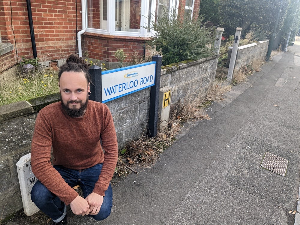 Chris Rigby next to pavement weeds in Waterloo Road, Winton